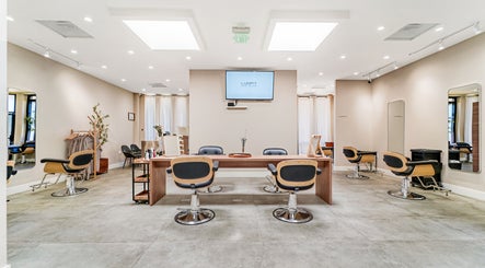 Spacious interior of Lunar Hair Salon in San Lorenzo, California, US showcasing modern styling chairs and mirrors.