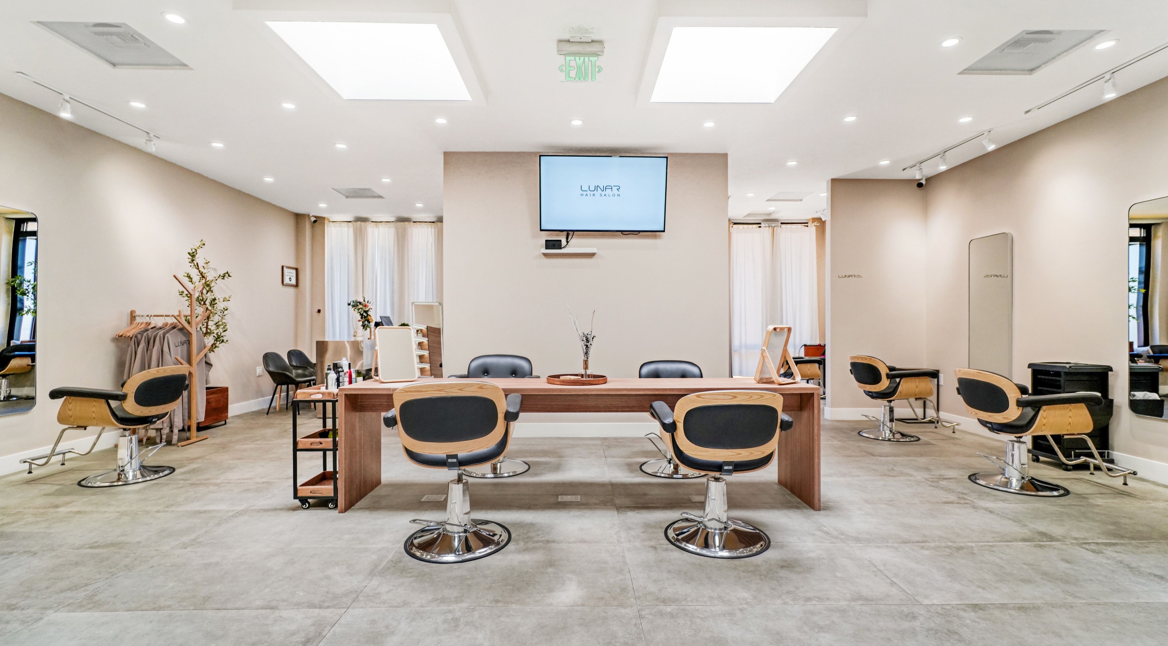 Bright interior of Lunar Hair Salon, San Lorenzo, California, US, with modern styling chairs and sleek decor.