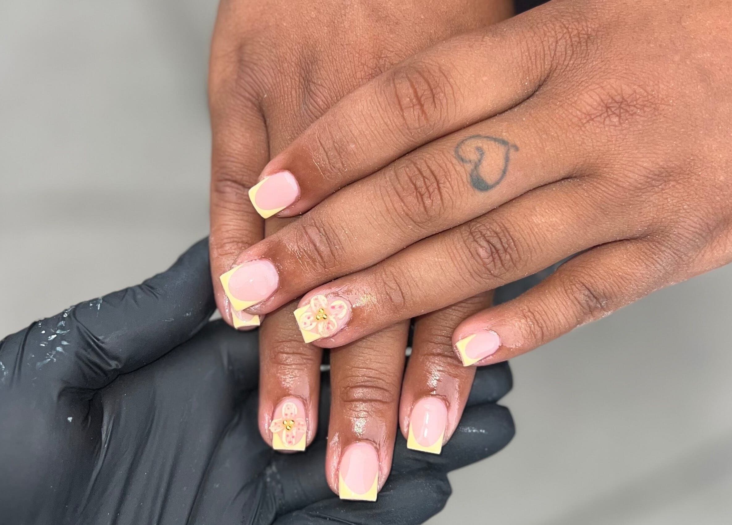 Floral-themed French manicure at Nails by jodie-lea, Eccles, England, GB, showcasing expert nail art.