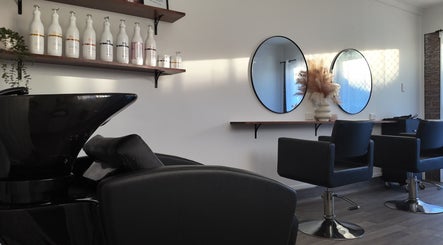Chic interior of Brooke & Co Hair Salon in Brassall, Queensland, AU, featuring sleek chairs and modern decor.