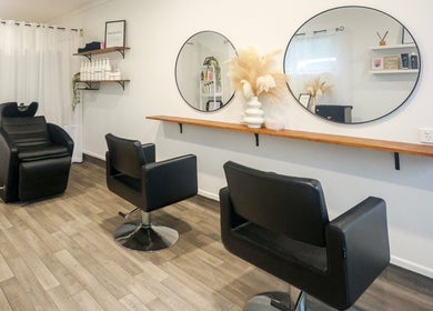 Chic interior of Brooke & Co Hair Salon in Ipswich, Queensland, AU with stylish seating and mirrors.