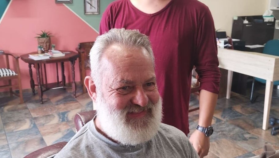 Customer enjoying a fresh trim at Tame Your Mane Barbershop, Cape Town, Western Cape, ZA.
