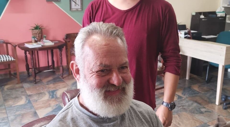 Customer enjoying a fresh trim at Tame Your Mane Barbershop, Cape Town, Western Cape, ZA.