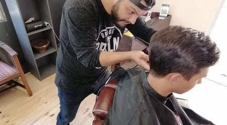Barber crafts trendy cut at Tame Your Mane Barbershop, Cape Town, Western Cape, ZA.