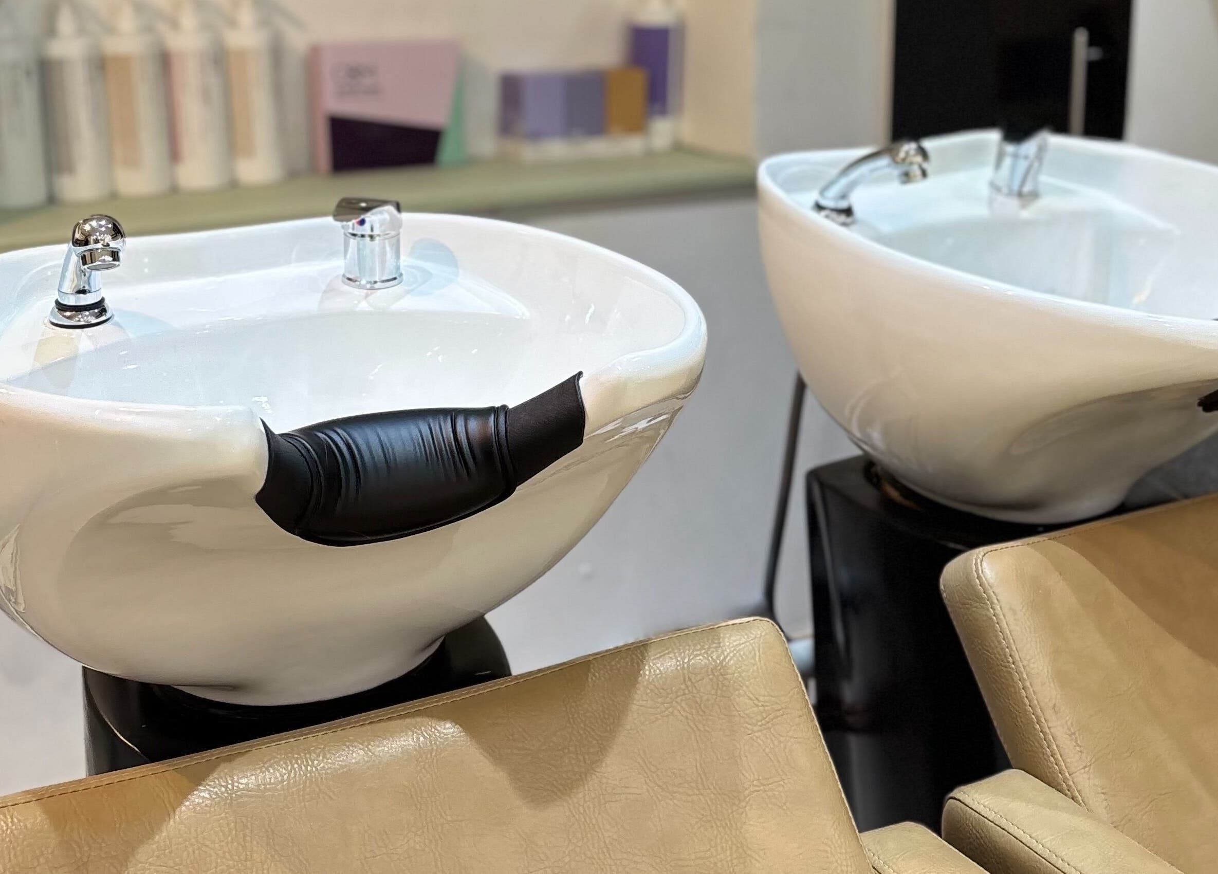 Sleek washbasins at Irvine Hair Studio, Bolton, England, GB, showcasing modern salon elegance.
