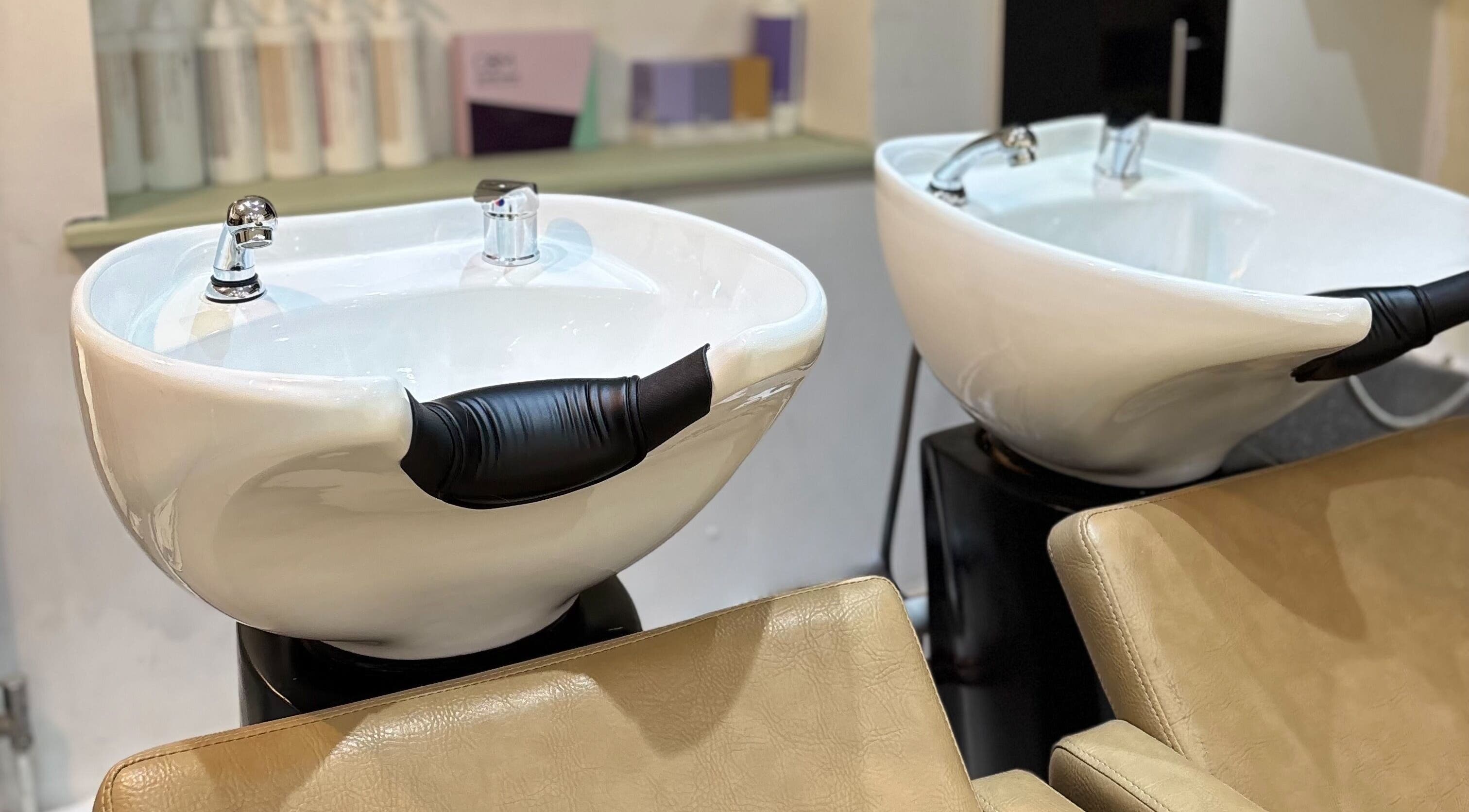 Sleek washbasins at Irvine Hair Studio, Bolton, England, GB, showcasing modern salon elegance.