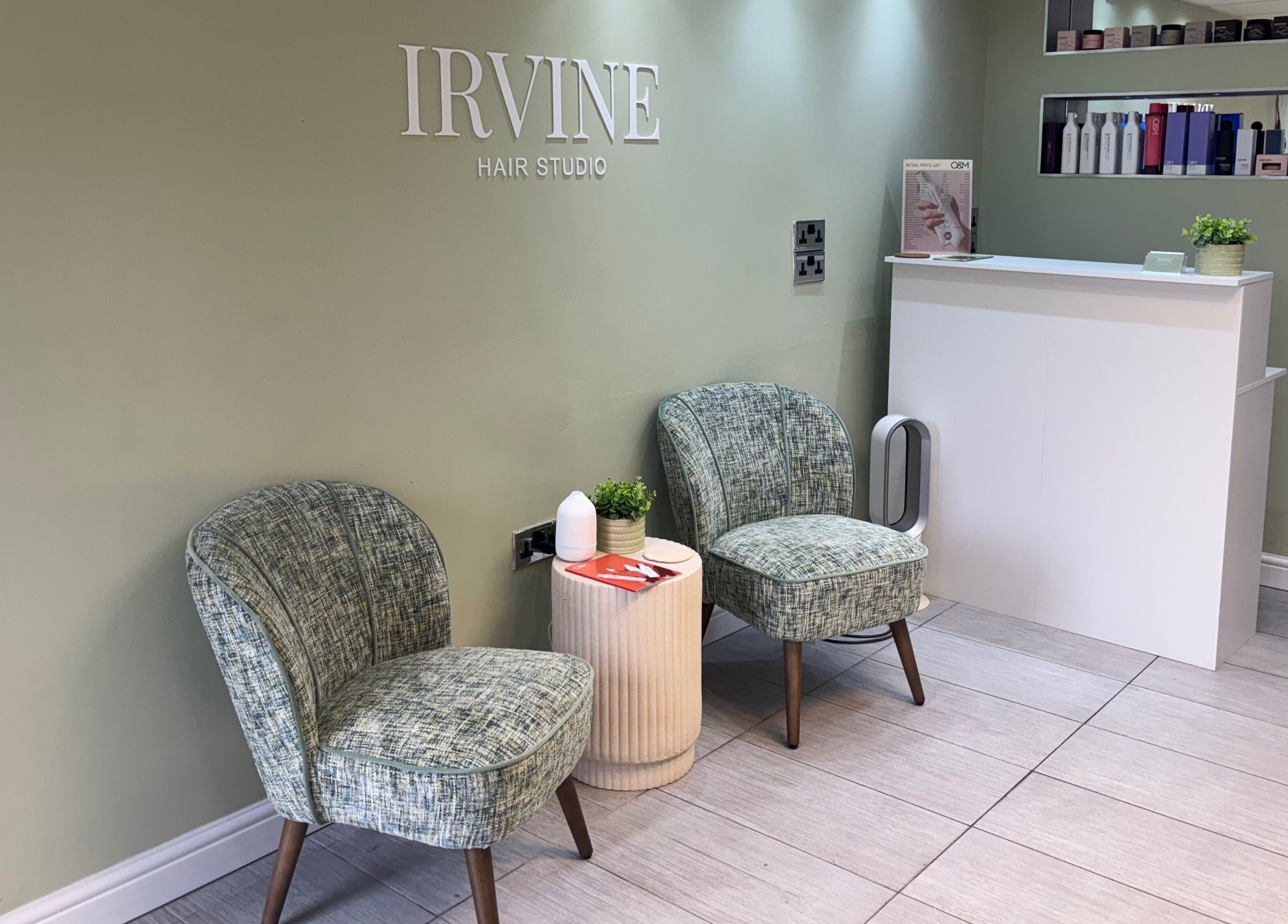 Chic waiting area at Irvine Hair Studio, Bolton, England, GB, featuring stylish seating and modern decor.