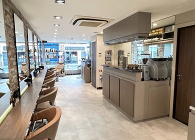 Interior of RYS Hair and Beauty, a chic salon in London, England, GB featuring stylish chairs and mirrors.