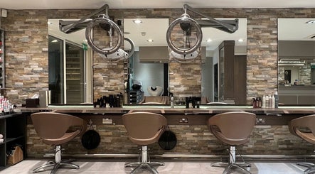 Modern salon interior at RYS Hair and Beauty in London, England, GB, featuring elegant styling chairs and mirrors.