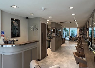 Interior of RYS Hair and Beauty, London, England, GB, featuring elegant styling stations and modern decor.