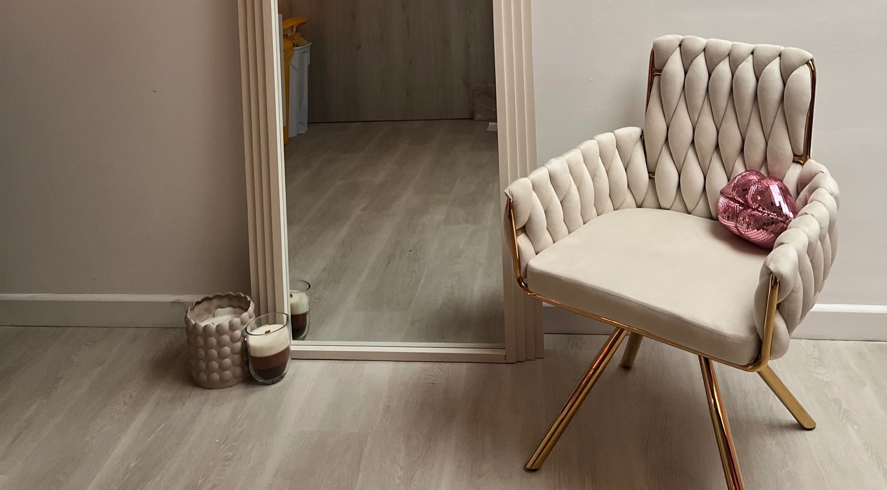 Cozy chair by a mirror at Love Mi Aesthetics, Weymouth, England, GB, showcasing a serene beauty space.