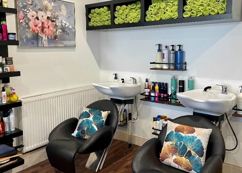 Elegant salon wash area at MAJ STUDIO, Twickenham, England, GB, featuring plush chairs and vibrant decor.