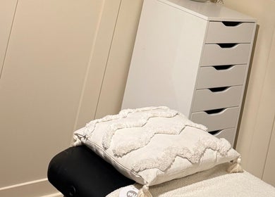 Relaxing spa room at All About Beauty in Ripley, England, GB, featuring a cozy massage table with soft cushions.
