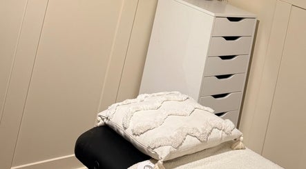 Relaxing spa room at All About Beauty in Ripley, England, GB, featuring a cozy massage table with soft cushions.