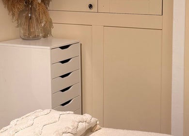Serene massage room at All About Beauty, Ripley, England, GB with elegant decor and storage.