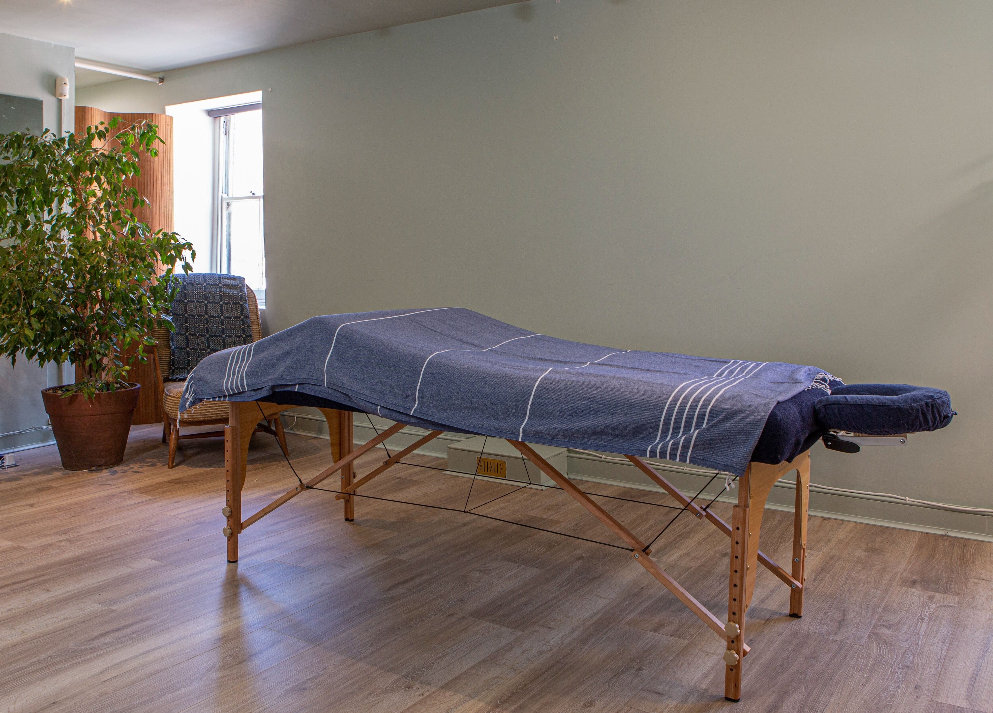 Massage room at Breathe Wellbeing, Brighton And Hove, England, GB, featuring a tranquil setting and massage table.