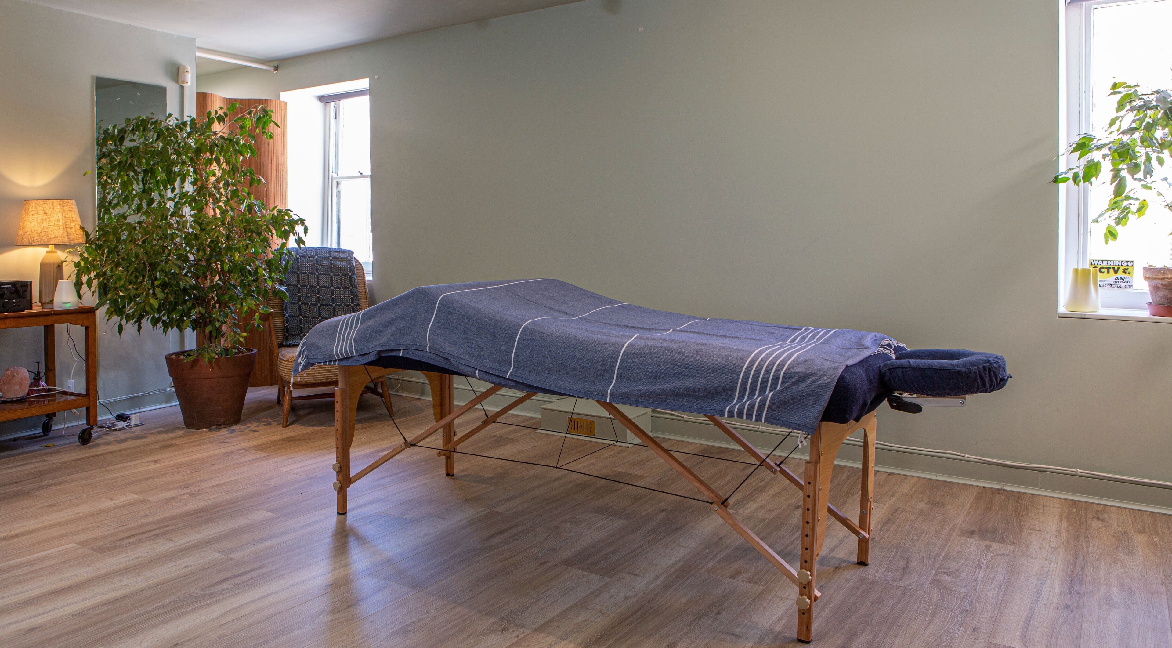 Massage room at Breathe Wellbeing, Brighton And Hove, England, GB, featuring a tranquil setting and massage table.