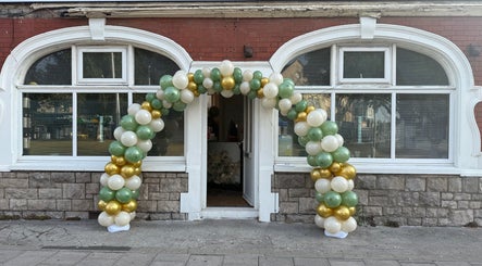 Entrance of Fresh in Weston-super-mare, England, GB, adorned with a green, cream, and gold balloon arch.