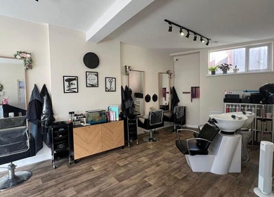 Modern salon interior at Fresh in Weston-super-mare, England, GB, featuring stylish salon chairs and wash stations.