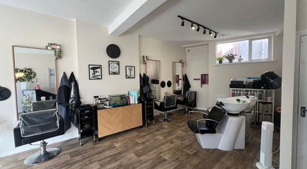 Modern salon interior at Fresh in Weston-super-mare, England, GB, featuring stylish salon chairs and wash stations.