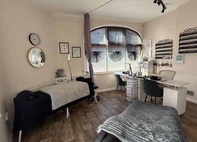 Calming beauty treatment room at Fresh, Weston-super-Mare, England, GB, with cozy massage bed and nail station.