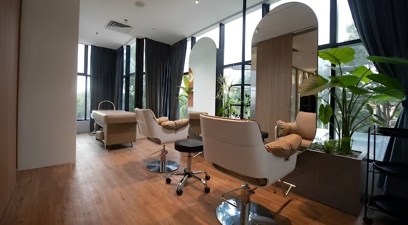 Modern salon interior at Snip & Drip in Petaling Jaya, Selangor, MY featuring chic chairs and large mirrors.