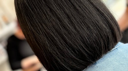 Close-up of a sleek bob haircut at JH Hair in Stalybridge, England, GB, showcasing glossy dark hair.