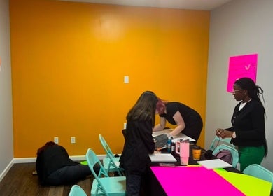 Creative workshop at Ascend Beauty College Scottsboro Campus, Scottsboro, Alabama, US with participants at tables.