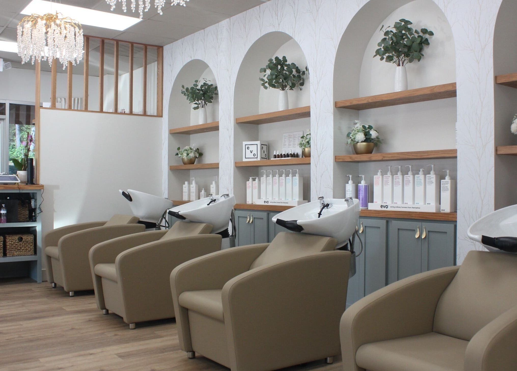 Elegant interior of Restored Beauty Bar and Head Spa in Richmond, Virginia, US with plush chairs and modern decor.