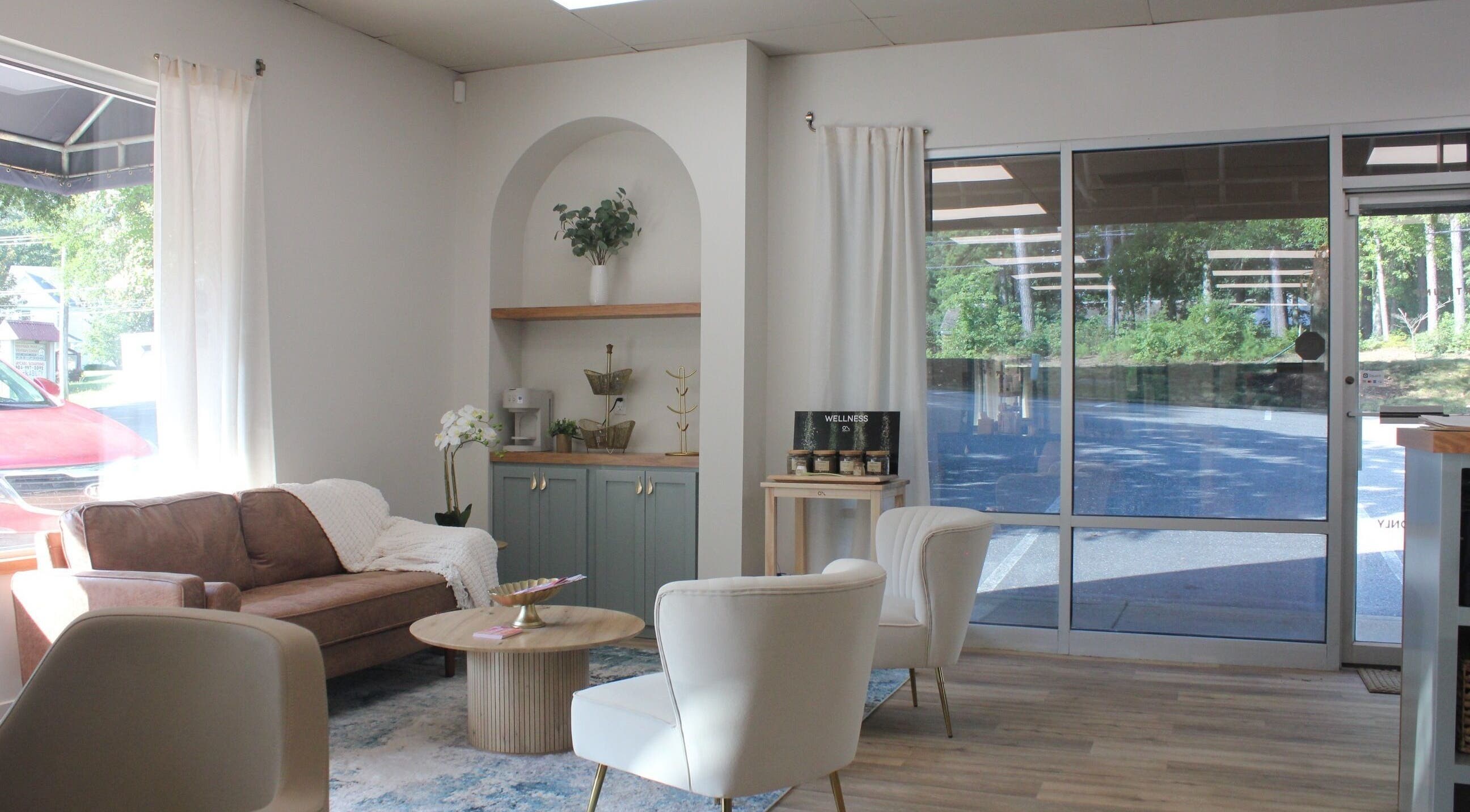 Inviting lounge area at Restored Beauty Bar and Head Spa in Richmond, Virginia, US. Cozy and stylish decor.
