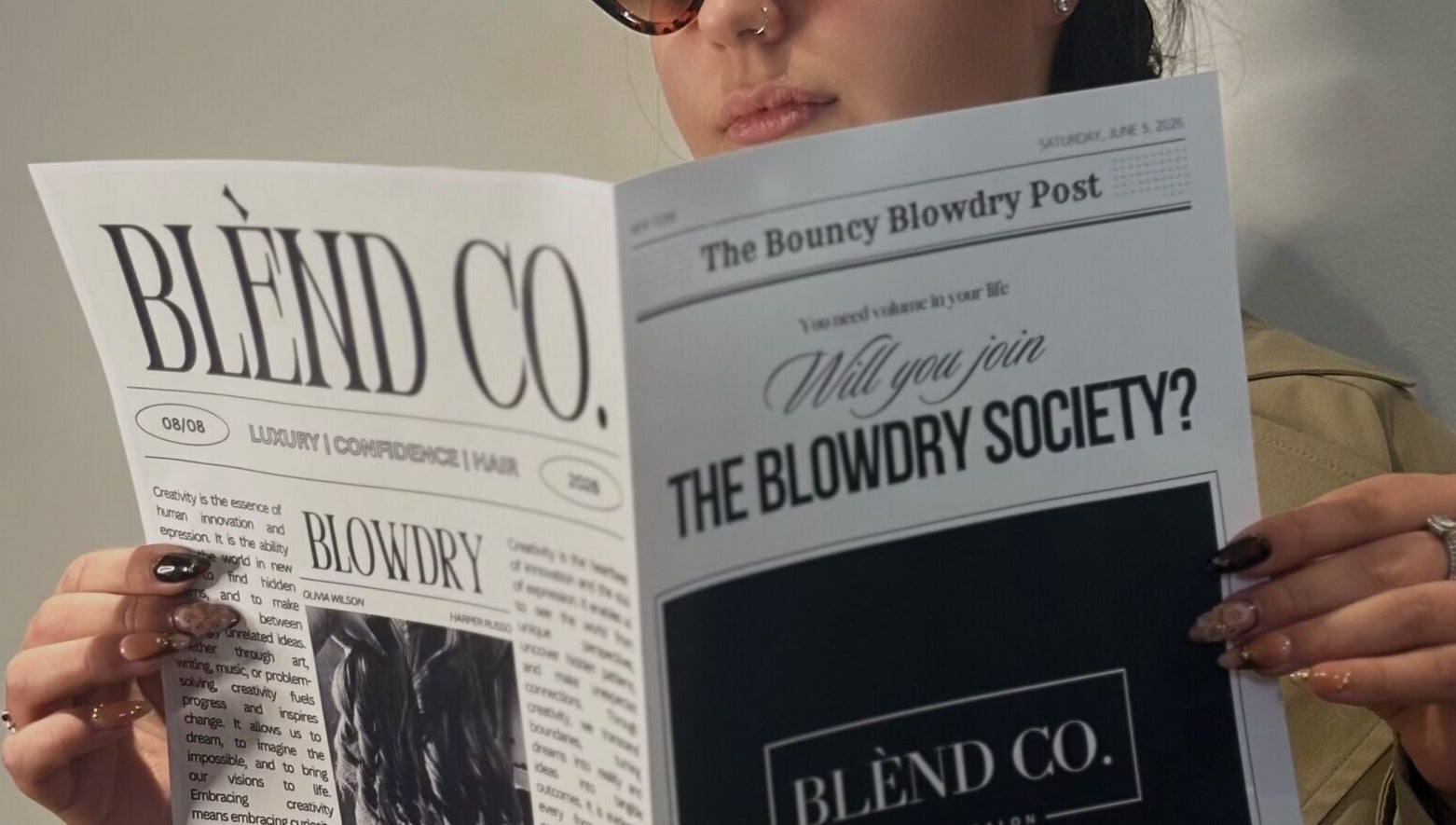 Person reading Blènd Co. newsletter in Stafford, England, GB salon setting.