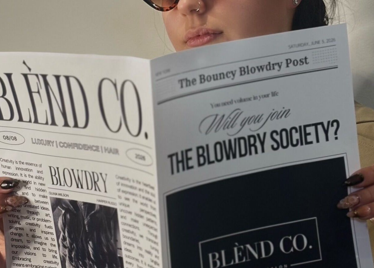 Person reading Blènd Co. newsletter in Stafford, England, GB salon setting.