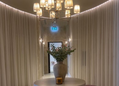 Sophisticated foyer at Exhale By Elegance, Stapleford, England, GB with chic chandeliers and a vase centerpiece.