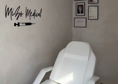 Treatment room at Mizo Medical Aesthetics, Hazel Grove, England, GB showcasing a comfortable white chair.