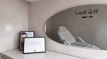 Calm treatment room at Mizo Medical Aesthetics, Hazel Grove, England, GB with diploma and sleek decor.