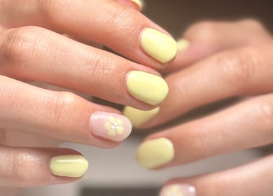 Yellow manicured nails with floral design at Still Gloss by Abi, Basingstoke, England, GB.