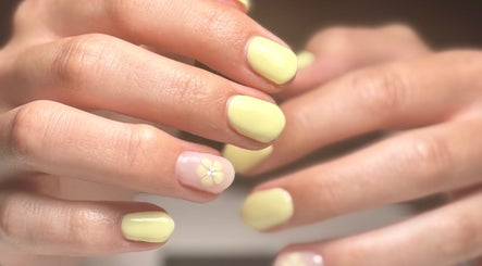 Yellow manicured nails with floral design at Still Gloss by Abi, Basingstoke, England, GB.