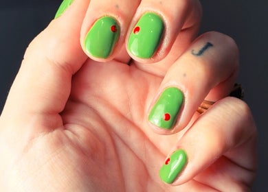 Bright green manicure with red accents at Still Gloss by Abi, Basingstoke, England, GB.