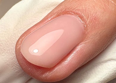 Close-up of a glossy pink manicure at Still Gloss by Abi, Basingstoke, England, GB.