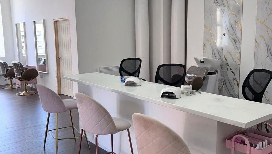 Chic interior of Skye Sculpting Lounge in Renfrew, Scotland, GB featuring modern salon chairs and styling stations.
