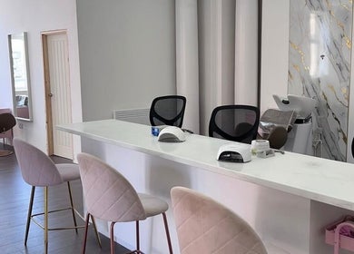 Chic interior of Skye Sculpting Lounge in Renfrew, Scotland, GB featuring modern salon chairs and styling stations.