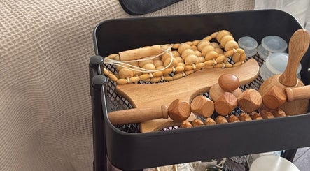 Wooden massage tools at Skye Sculpting Lounge, Renfrew, Scotland, GB, showcasing relaxation aids.