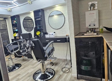 Modern interior of Mefalani Mobile Barbershop in Thorndale, Ontario, CA with stylish chairs and mirrors.