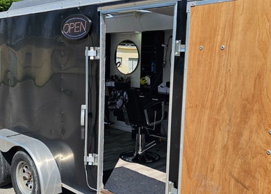 Open mobile barbershop trailer of Mefalani Mobile Barbershop in Thorndale, Ontario, CA.