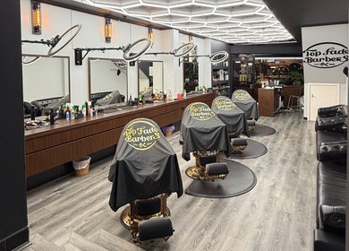 Interior of Top Fade Barbers, Melbourne, Victoria, AU, showcasing modern barber chairs and sleek decor.