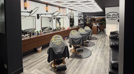 Interior of Top Fade Barbers, Melbourne, Victoria, AU, showcasing modern barber chairs and sleek decor.