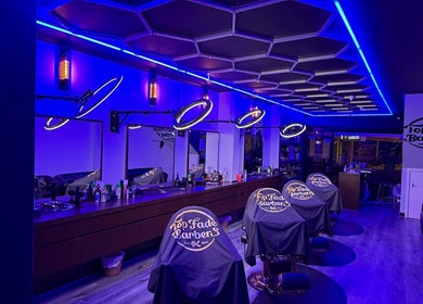 Interior of Top Fade Barbers in Melbourne, Victoria, AU with sleek neon lighting and modern barber chairs.