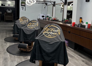 Interior of Top Fade Barbers in Melbourne, Victoria, AU showing elegant barber chairs and mirrors.