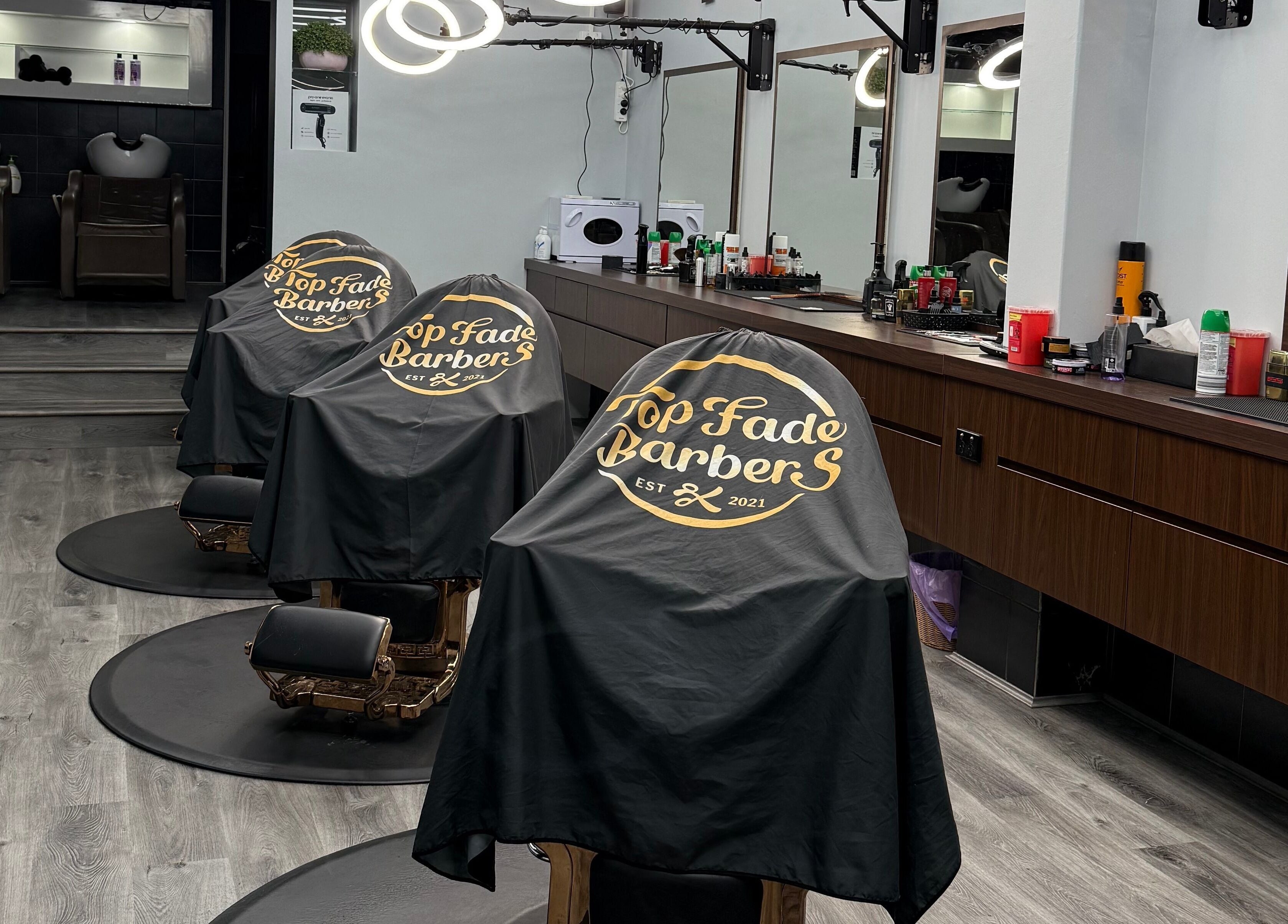 Stylish barber chairs at Top Fade Barbers Kew, Melbourne, Victoria, AU, showcasing a contemporary salon setup.