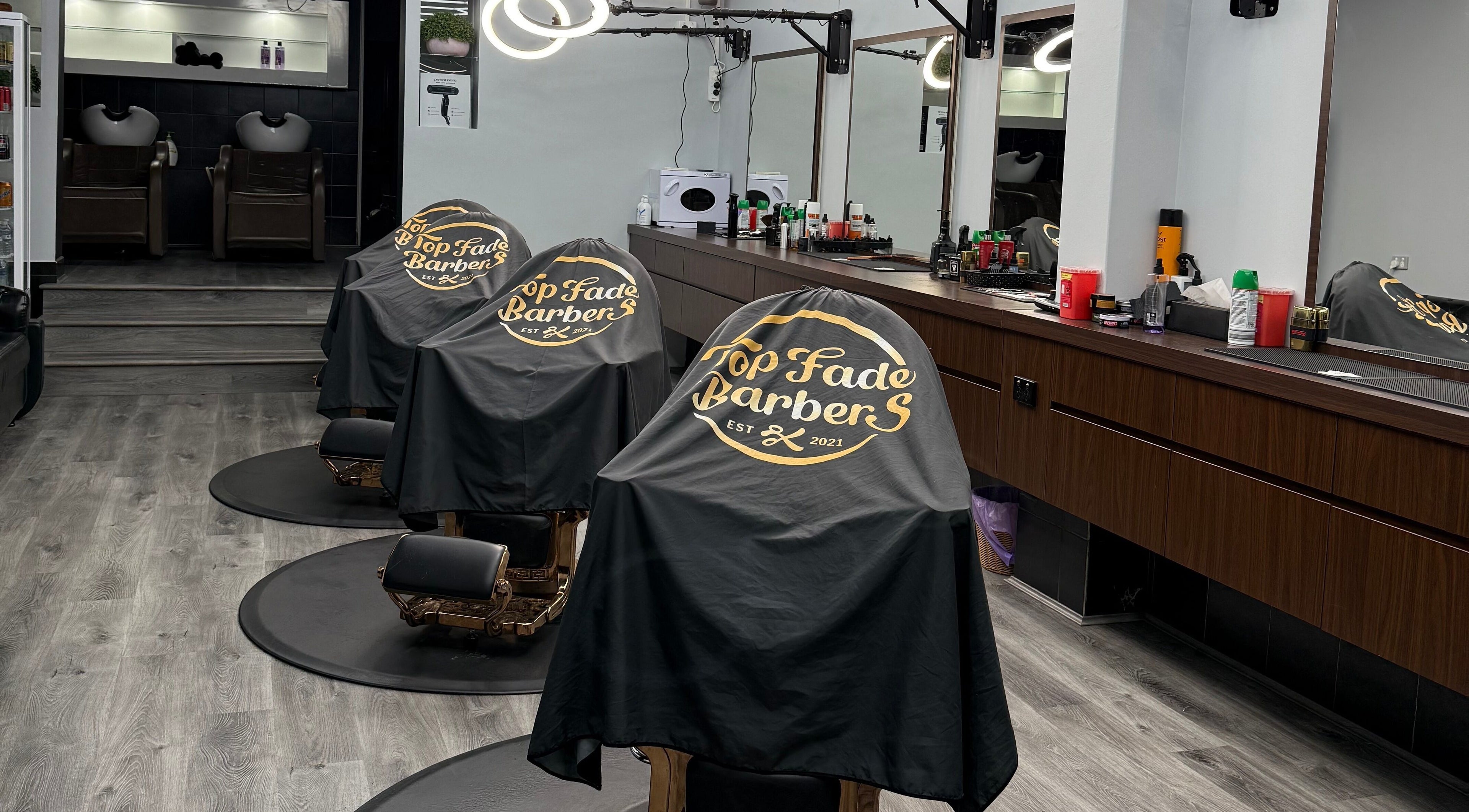 Stylish barber chairs at Top Fade Barbers Kew, Melbourne, Victoria, AU, showcasing a contemporary salon setup.